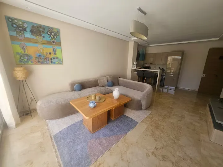 Modern living room area with open view to the kitchenette in Ciel Studio