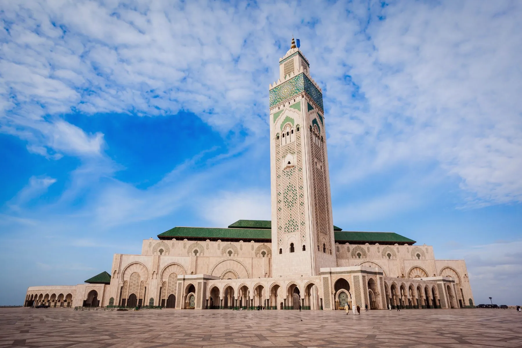 Grand view of the Hassan II Mosque minaret against a blue sky in Casablanca Morocco.